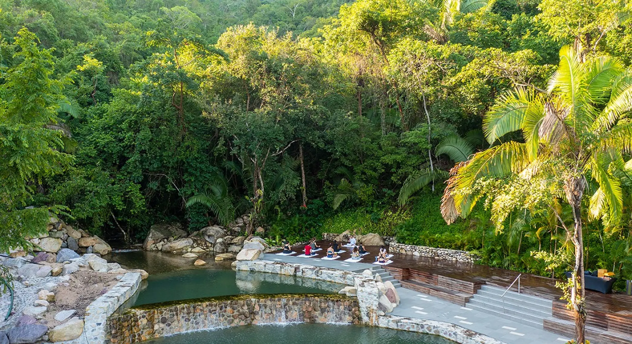 Natural stone pools surrounded by tropical jungle at Hotel Mousai, Puerto Vallarta