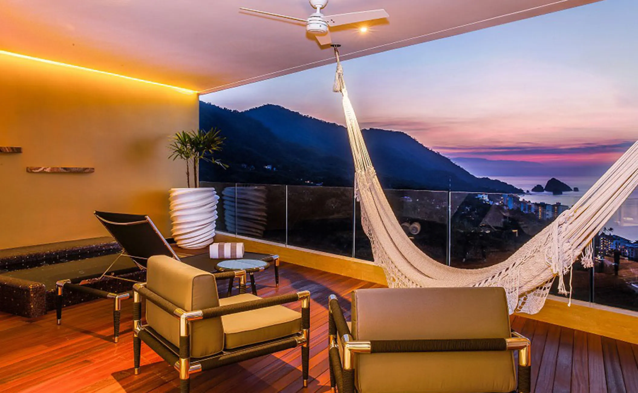The Penthouse suite terrace with a hammock and ocean sunset views at Hotel Mousai, Puerto Vallarta