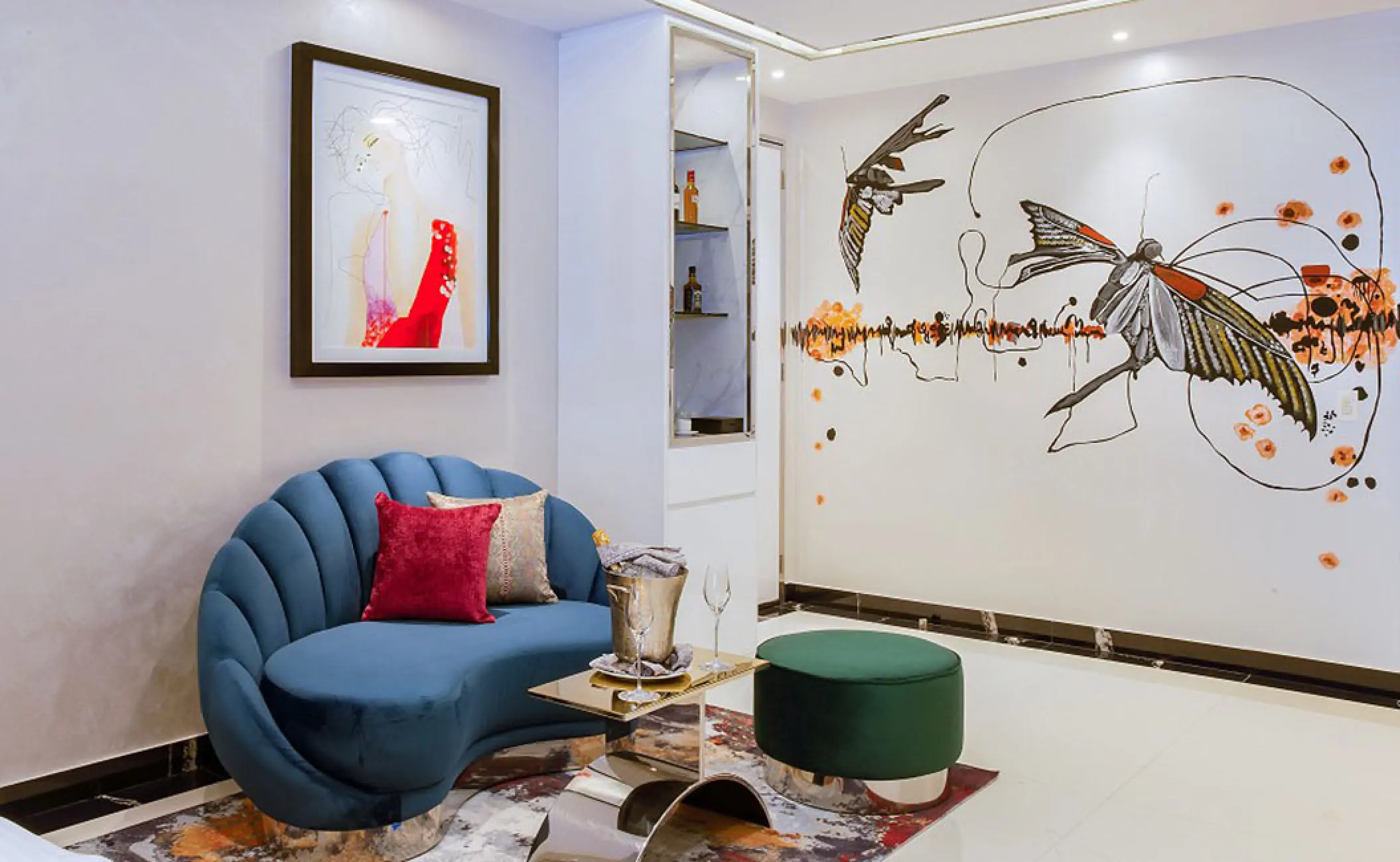Two-bedroom Mousai Suite living area with a blue shell-shaped sofa and wall mural at Hotel Mousai, Puerto Vallarta