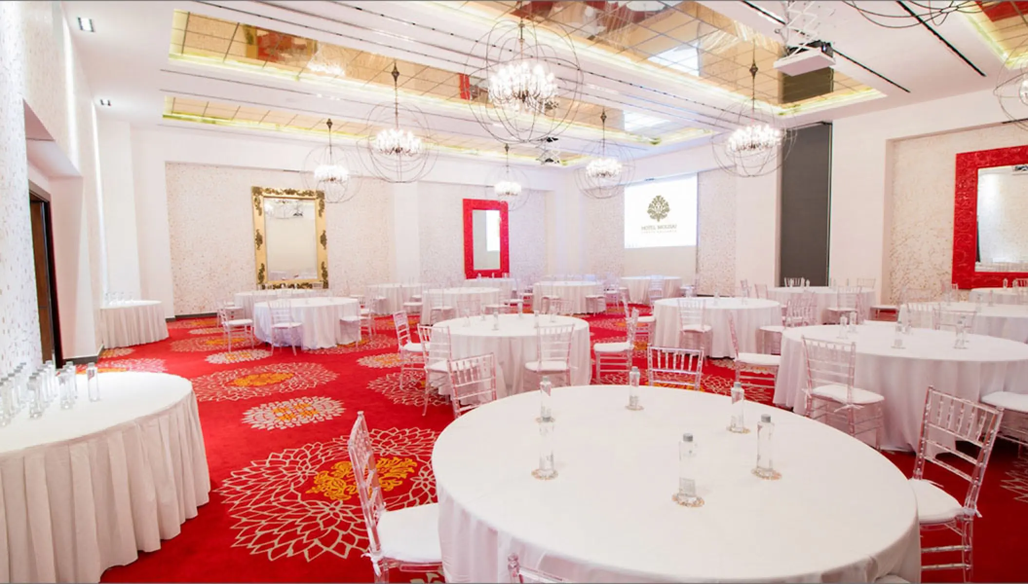 Red Room ballroom wedding reception with white tables at Hotel Mousai, Puerto Vallarta