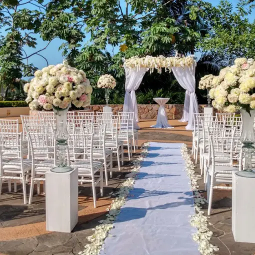Wedding ceremony setup with white chairs and floral arch at Garza Blanca Preserve, Puerto Vallarta