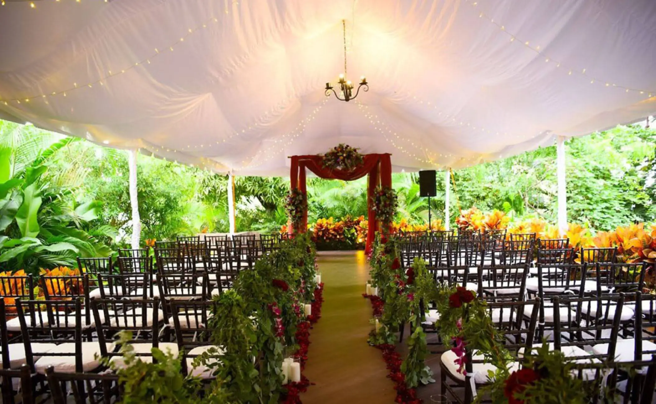 Garden wedding ceremony under a white canopy at Garza Blanca Puerto Vallarta