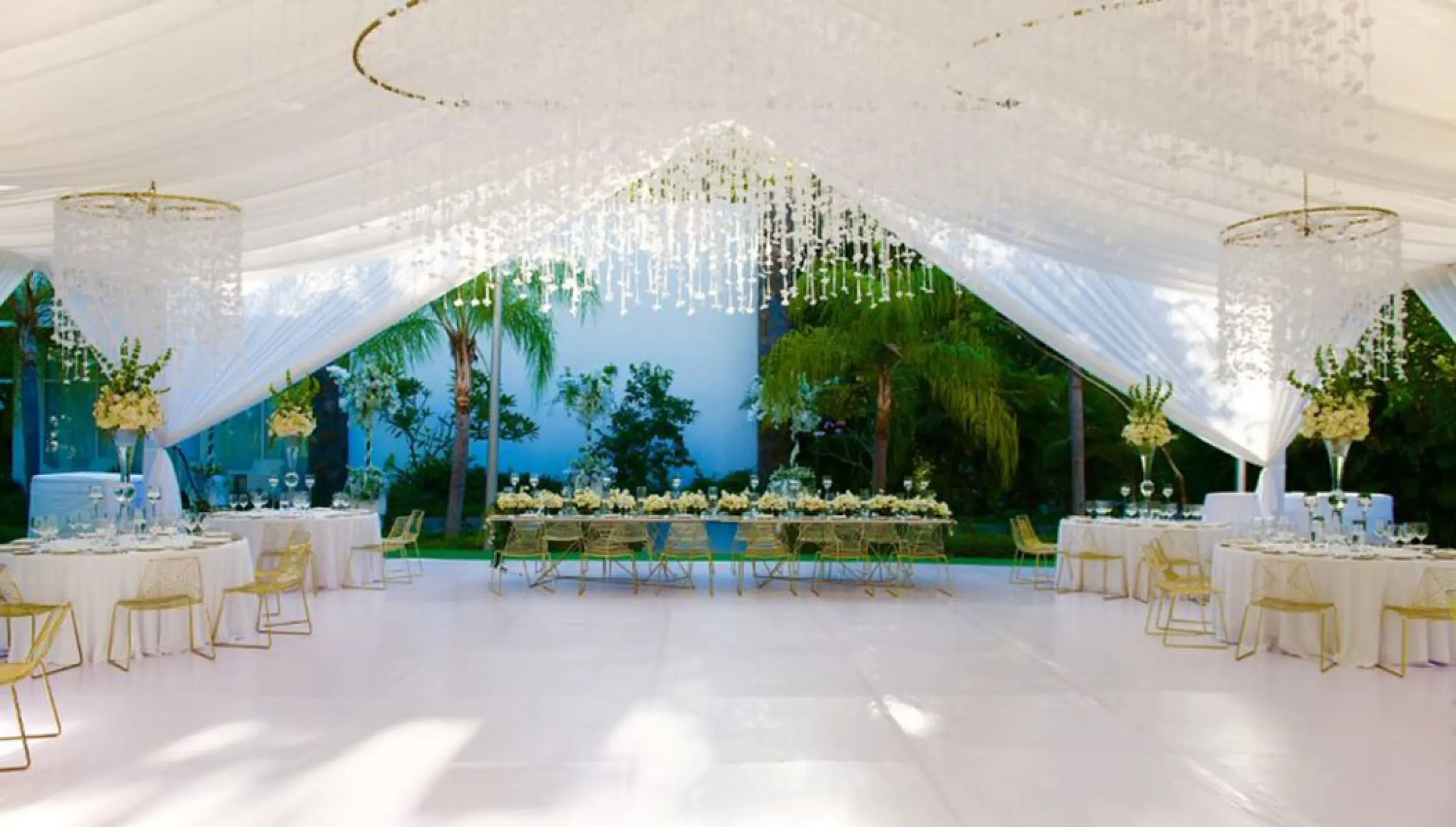 Outdoor wedding reception with white draping and hanging crystals at Garza Blanca Puerto Vallarta