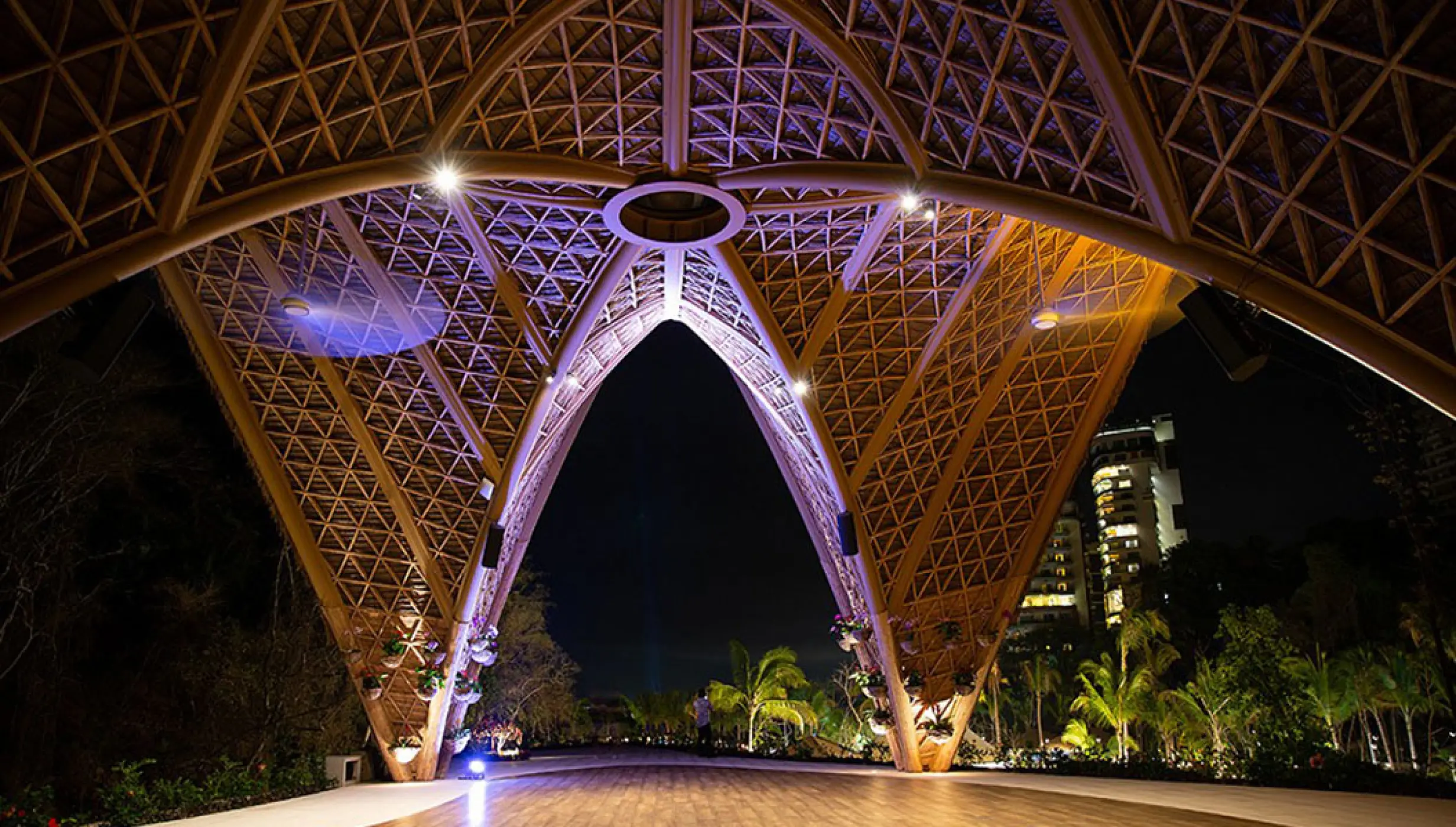 The Forum wedding venue with lit geometric canopy at night at Hotel Mousai, Puerto Vallarta