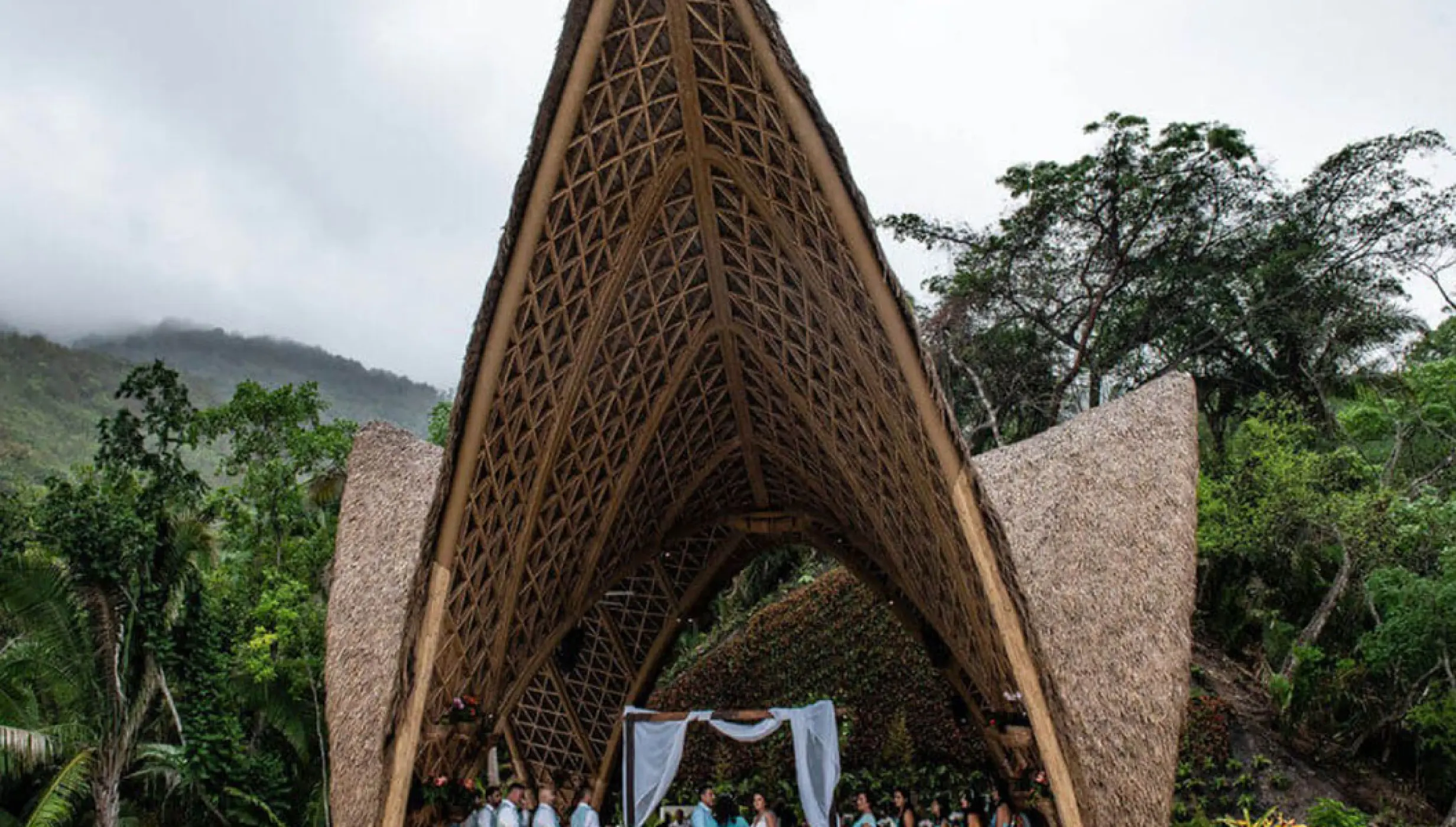 Wedding ceremony under the tall thatched pavilion at Garza Blanca Preserve, Puerto Vallarta