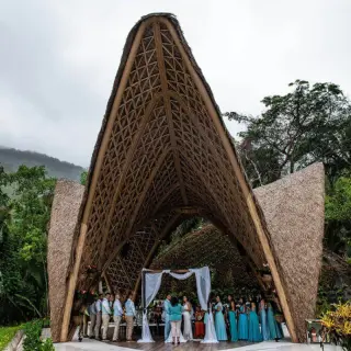 Wedding ceremony under a thatched bamboo pavilion at Garza Blanca Puerto Vallarta