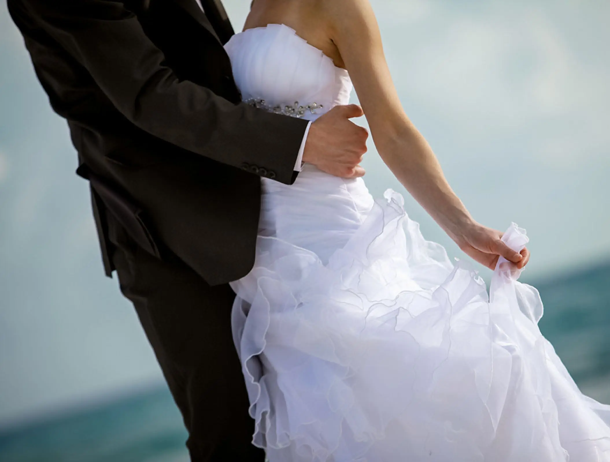 Close-up of a bride and groom embracing on the beach during a Secrets St. Lucia wedding