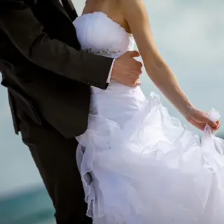 Close-up of a bride and groom embracing on the beach during a Secrets St. Lucia wedding