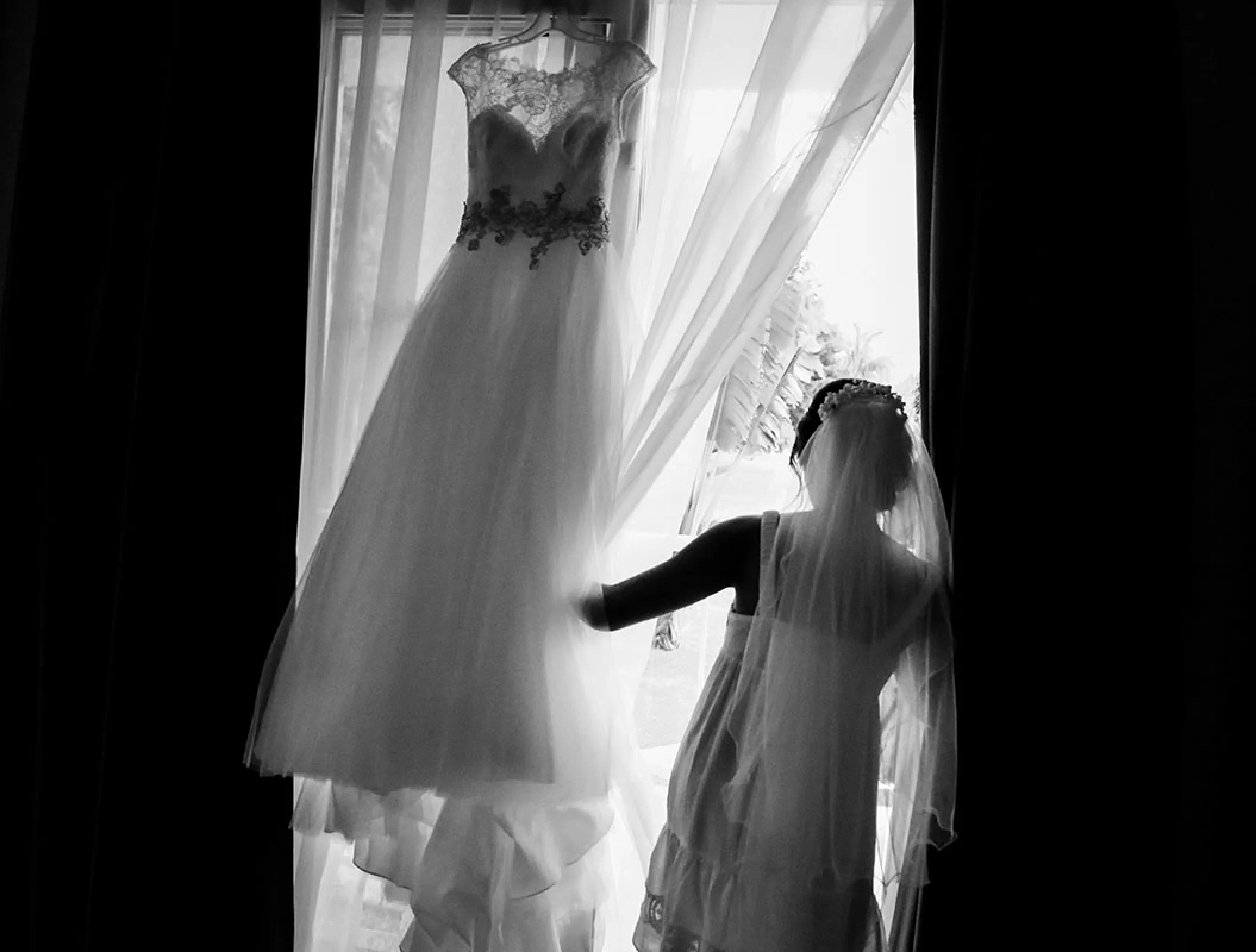 Bride Looking through the window while getting ready.