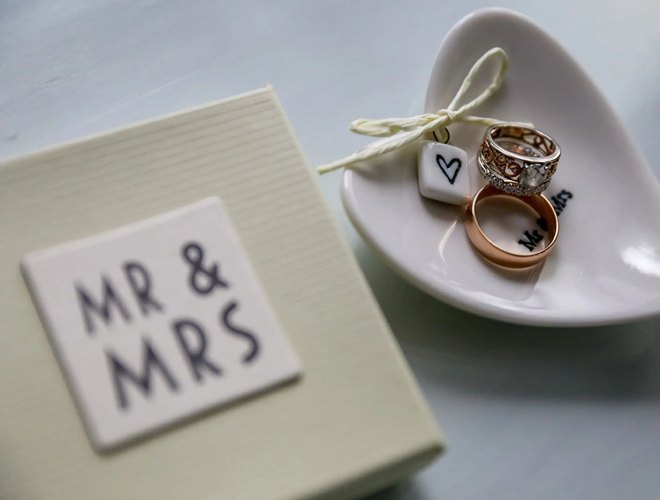 Wedding rings on a heart-shaped dish next to a Mr & Mrs box at Hyatt Ziva Los Cabos, Cabo San Lucas