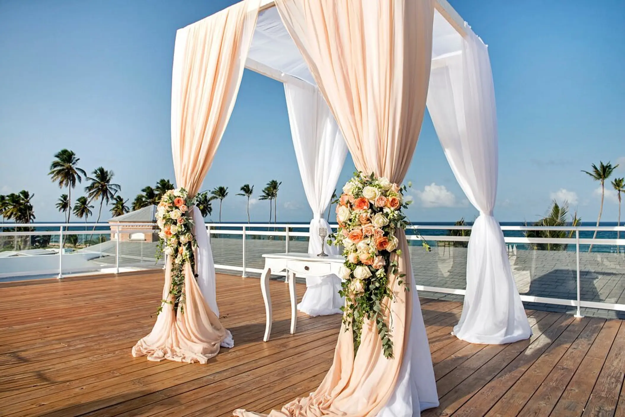 Sky terrace wedding ceremony setup with floral arch at Nickelodeon Punta Cana