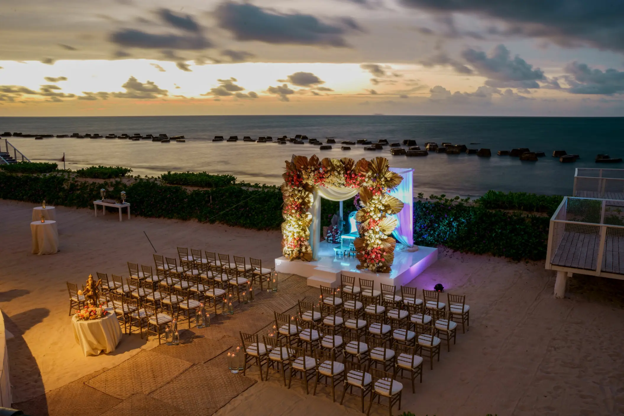 Beachfront wedding ceremony setup at Nickelodeon Riviera Maya at sunset, Riviera Maya