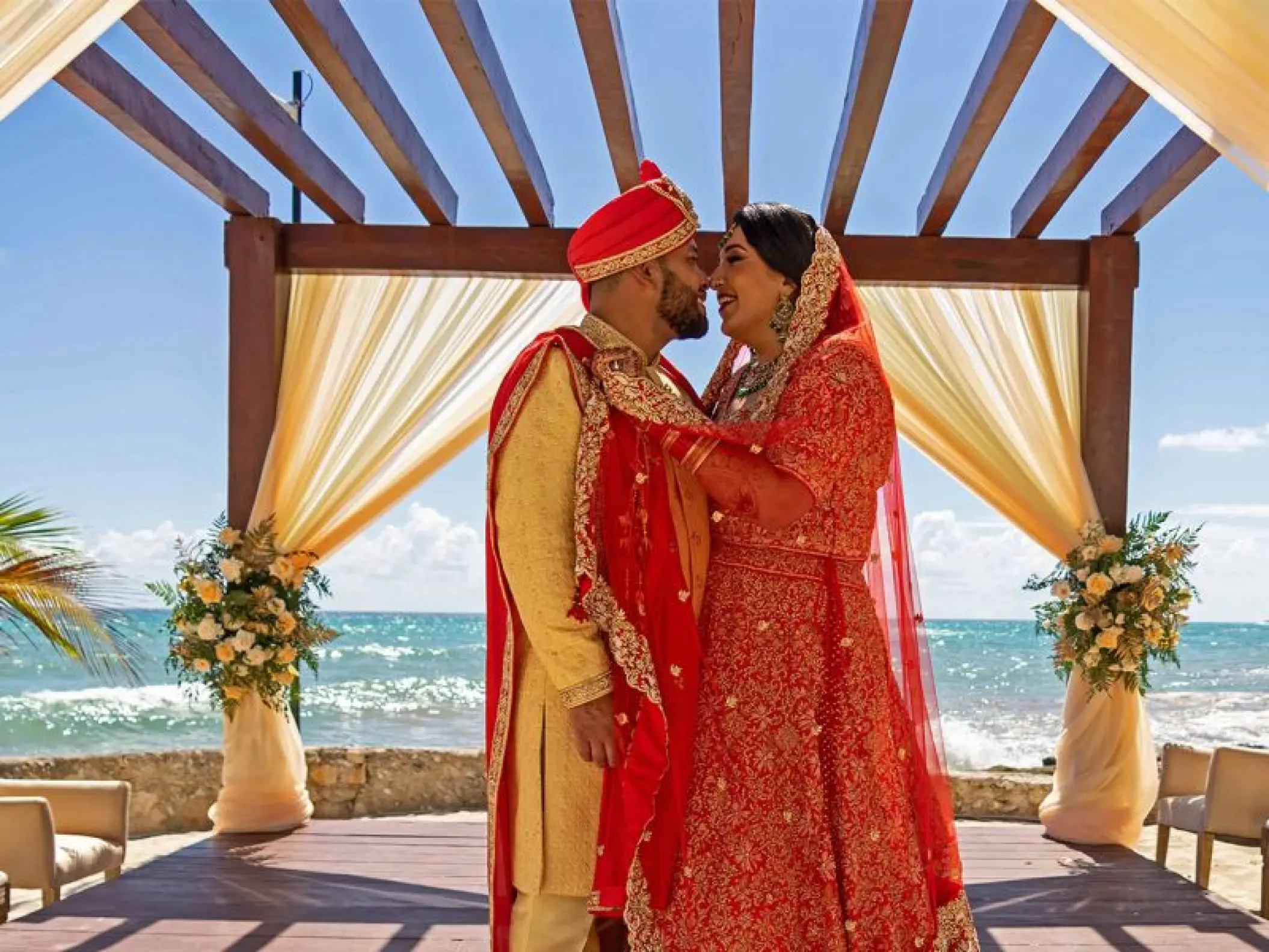 South Asian wedding ceremony at Nickelodeon Riviera Maya under a wooden gazebo by the ocean