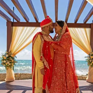 South Asian wedding ceremony at Nickelodeon Riviera Maya under a wooden gazebo by the ocean