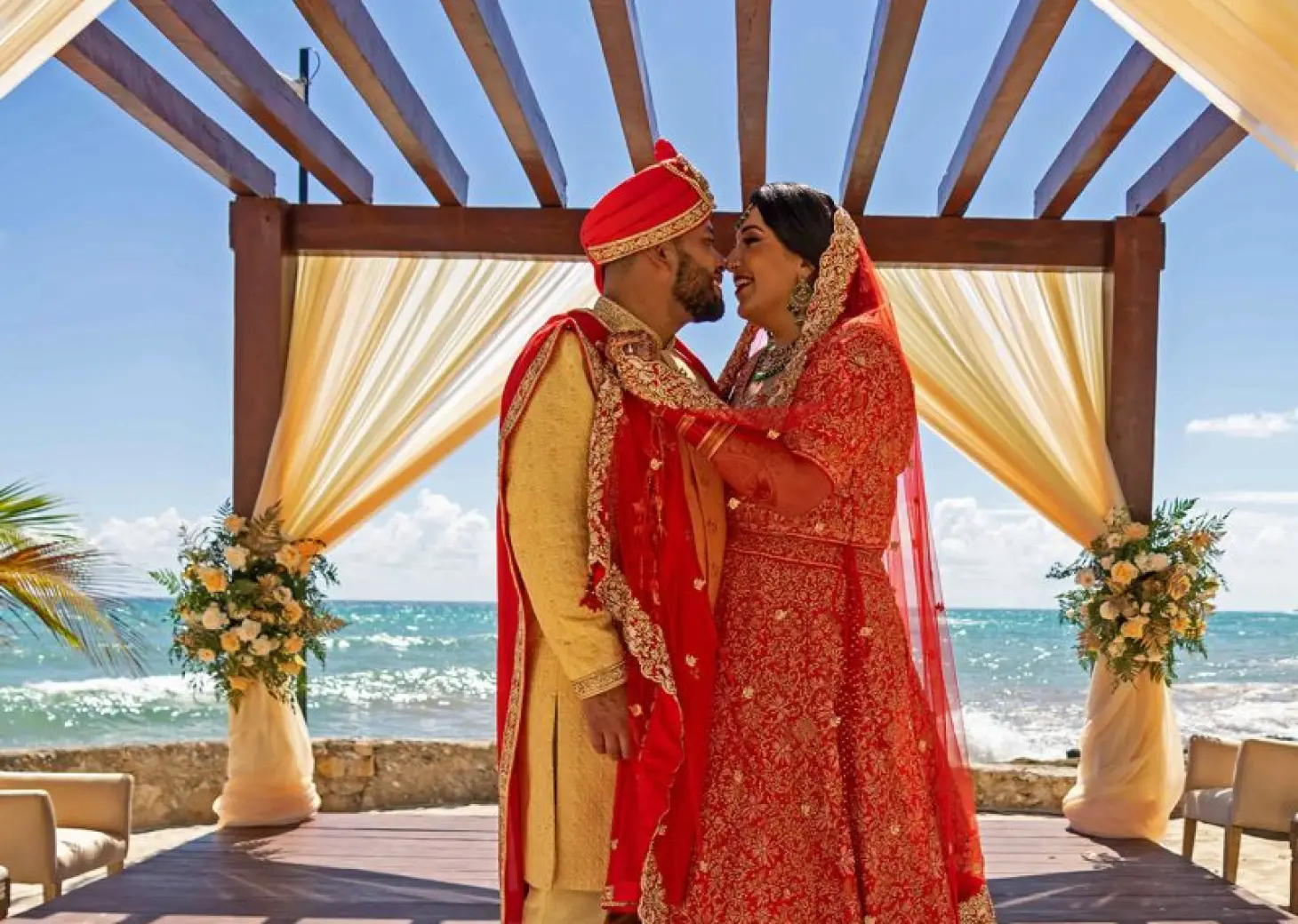 South Asian wedding ceremony at Nickelodeon Riviera Maya under a wooden gazebo by the ocean