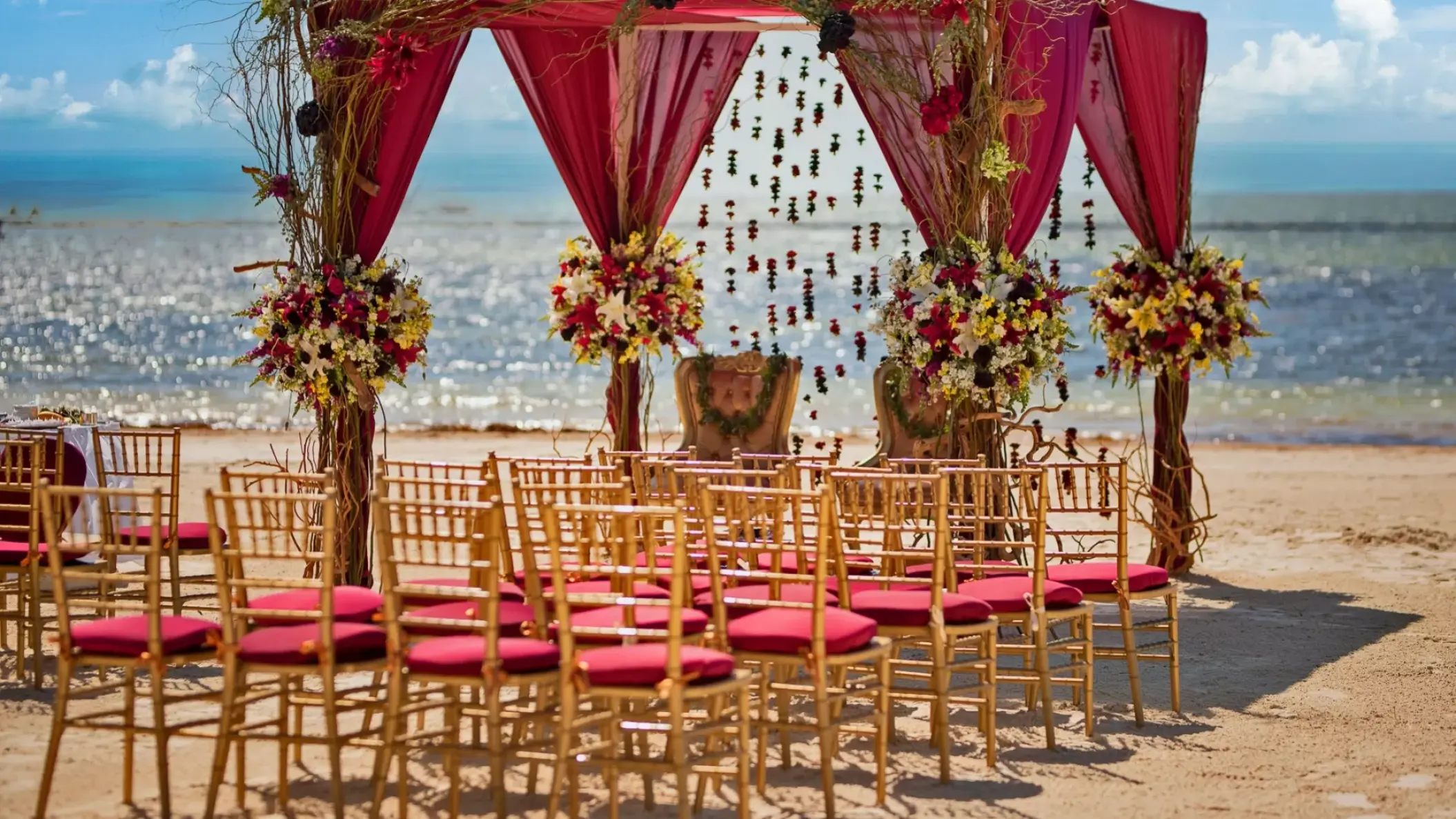 South Asian wedding mandap with pink draping and gold chairs at Nickelodeon Riviera Maya