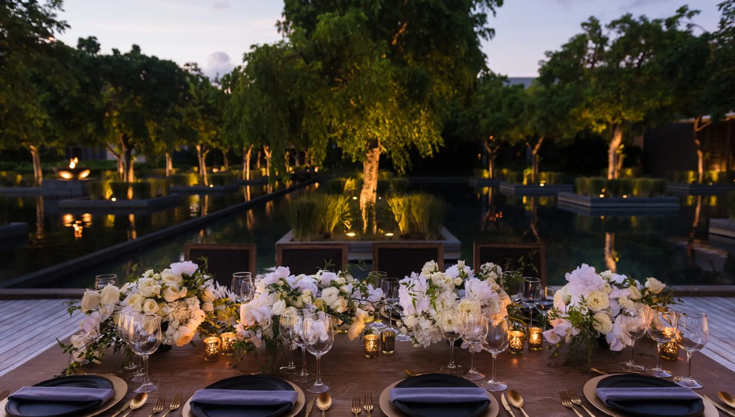 Akan Terrace wedding reception setup with white floral arrangements at Nizuc Resort, Cancun