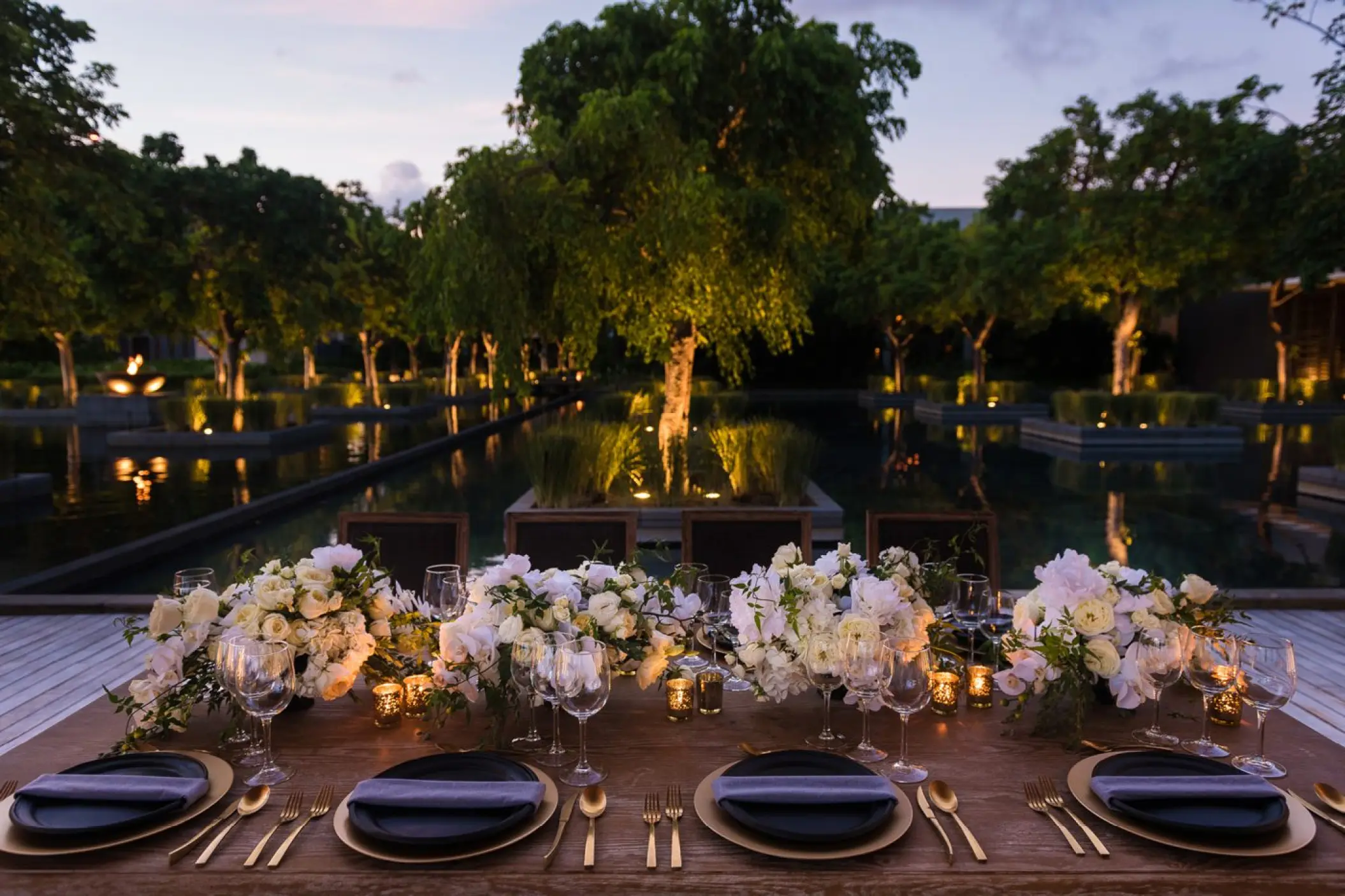 Akan Terrace wedding reception setup with white floral arrangements at Nizuc Resort, Cancun