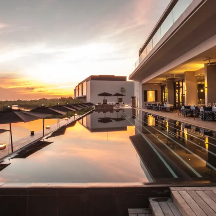 Nizuc Resort infinity pool at sunset with terrace dining, Cancun