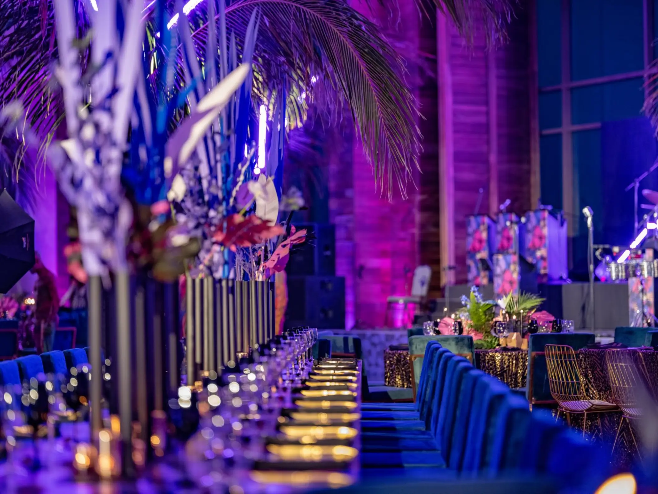 Indoor wedding reception with purple lighting and long tables at Nizuc Resort, Cancun