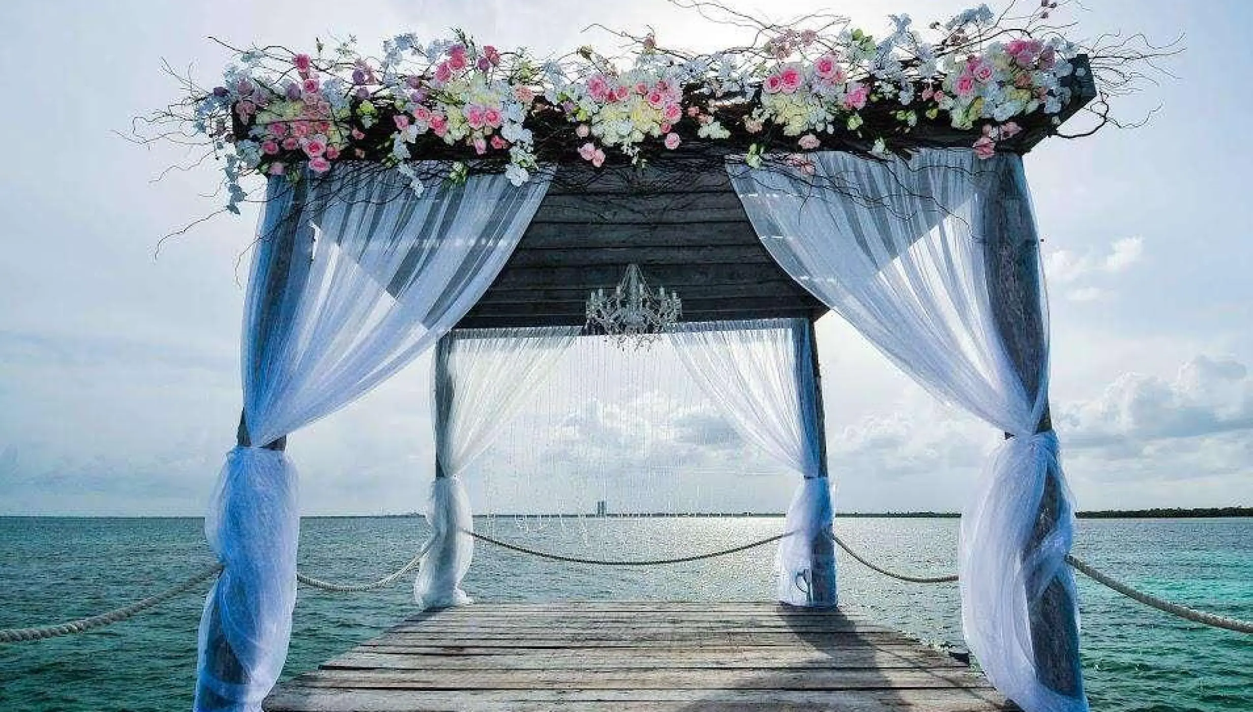 Ceremony decor on The pier wedding venue at Nizuc Resort and Spa