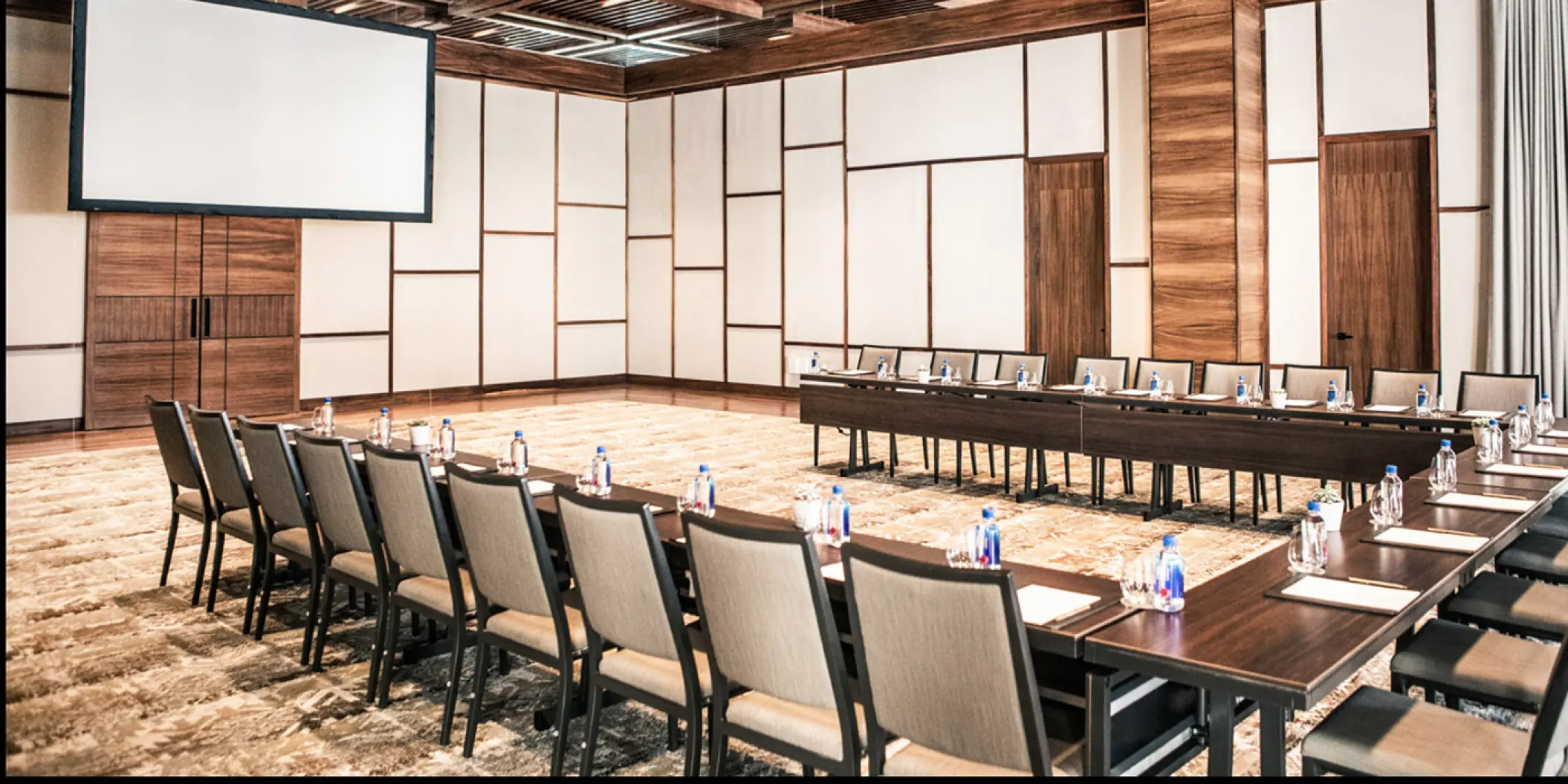 Aozora ballroom meeting setup with a projector screen at Nobu Hotel Los Cabos, Cabo San Lucas
