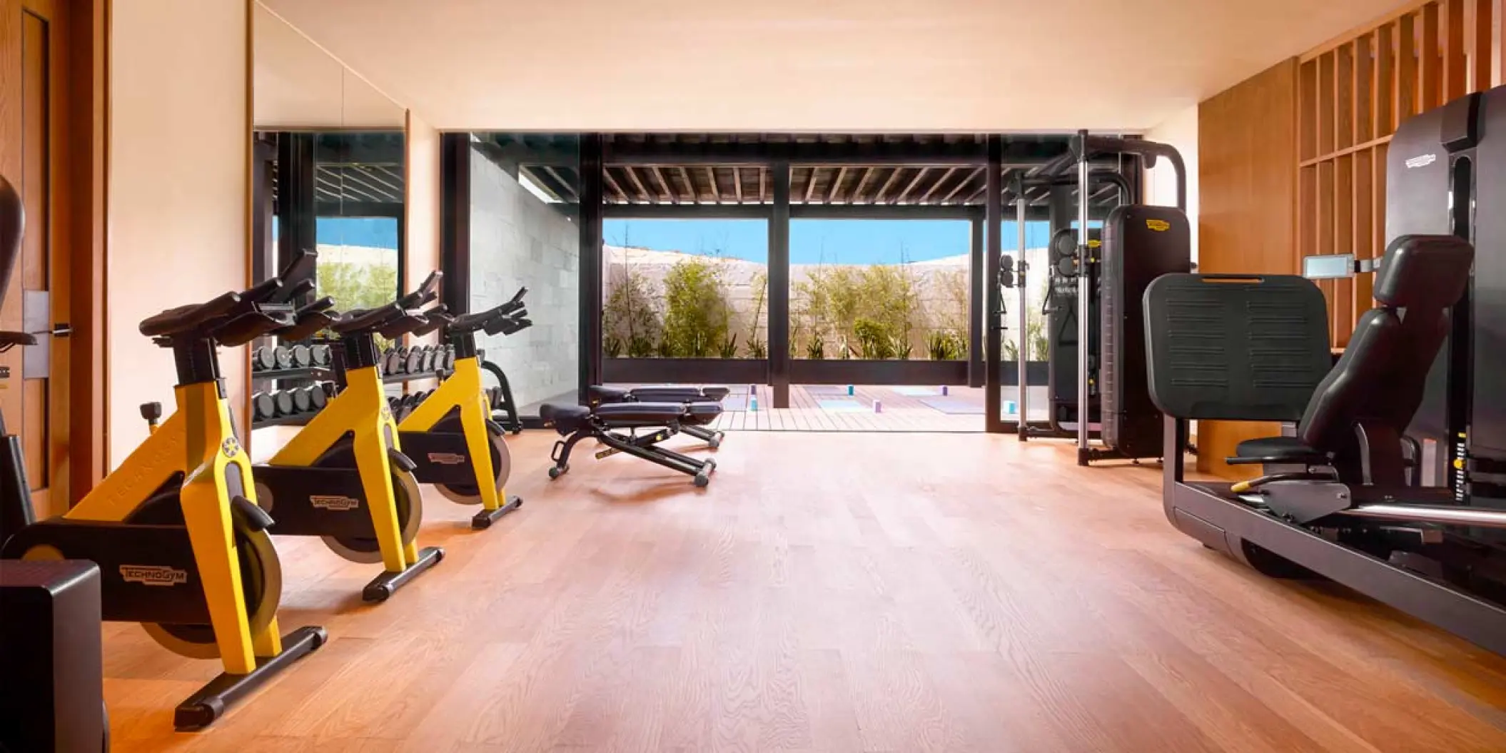 Modern fitness center with yellow stationary bikes at Nobu Hotel Los Cabos, Cabo San Lucas