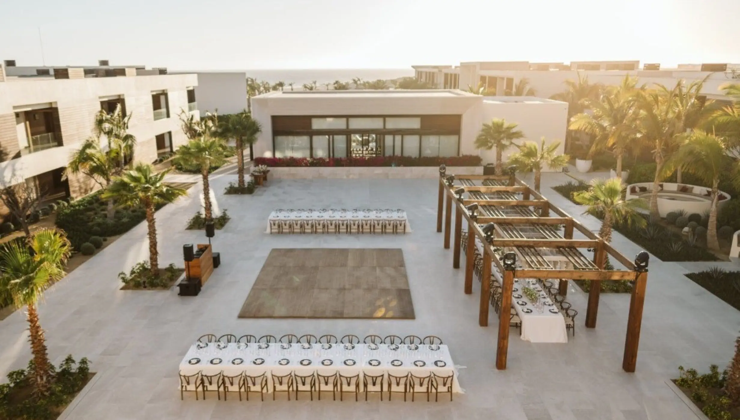 Outdoor wedding reception setup with dance floor on the Shiawase Terrace at Nobu Hotel, Cabo San Lucas