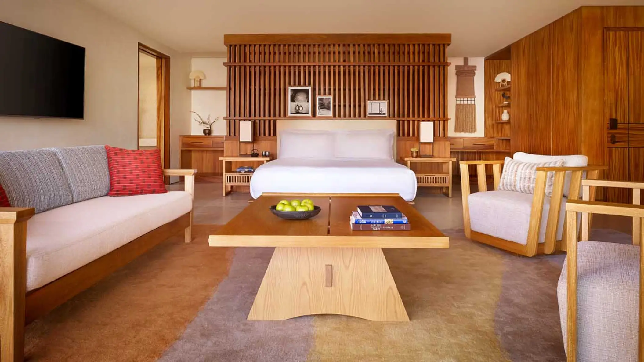 Modern wood-accented guest suite with sitting area and king bed at Nobu Hotel Los Cabos, Cabo San Lucas