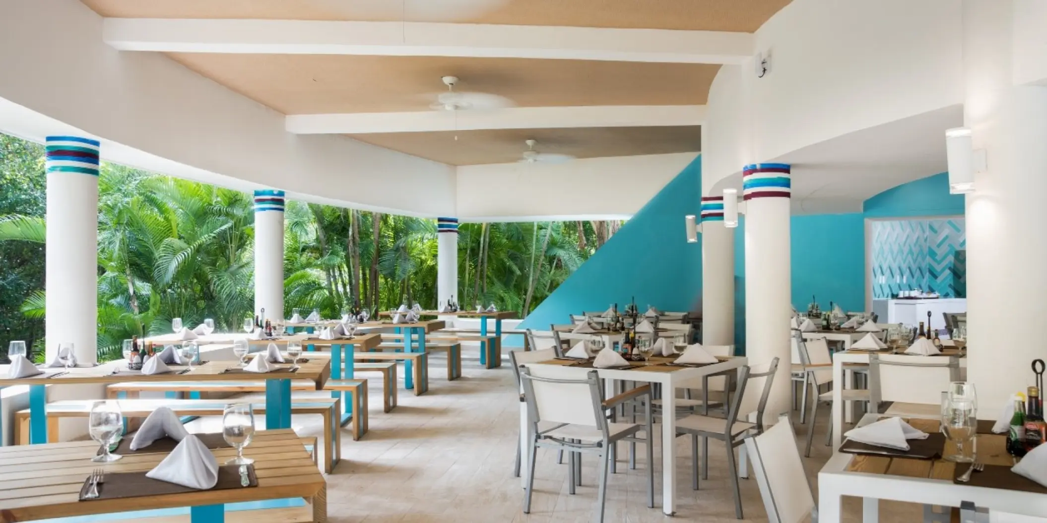 Outdoor restaurant with white and blue accents at Occidental at Xcaret Destination, Playa Del Carmen