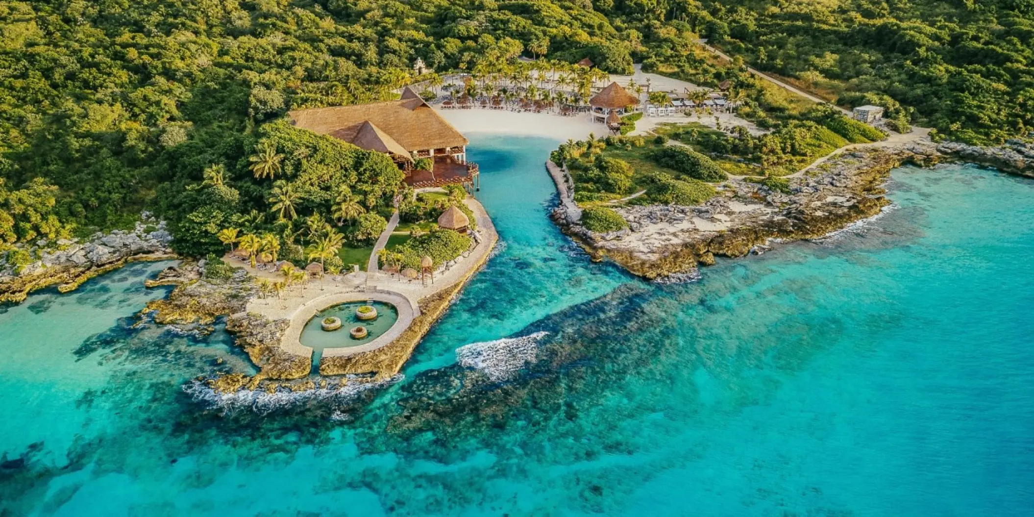 Aerial view of the private cove and turquoise ocean at Occidental at Xcaret Destination, Playa Del Carmen