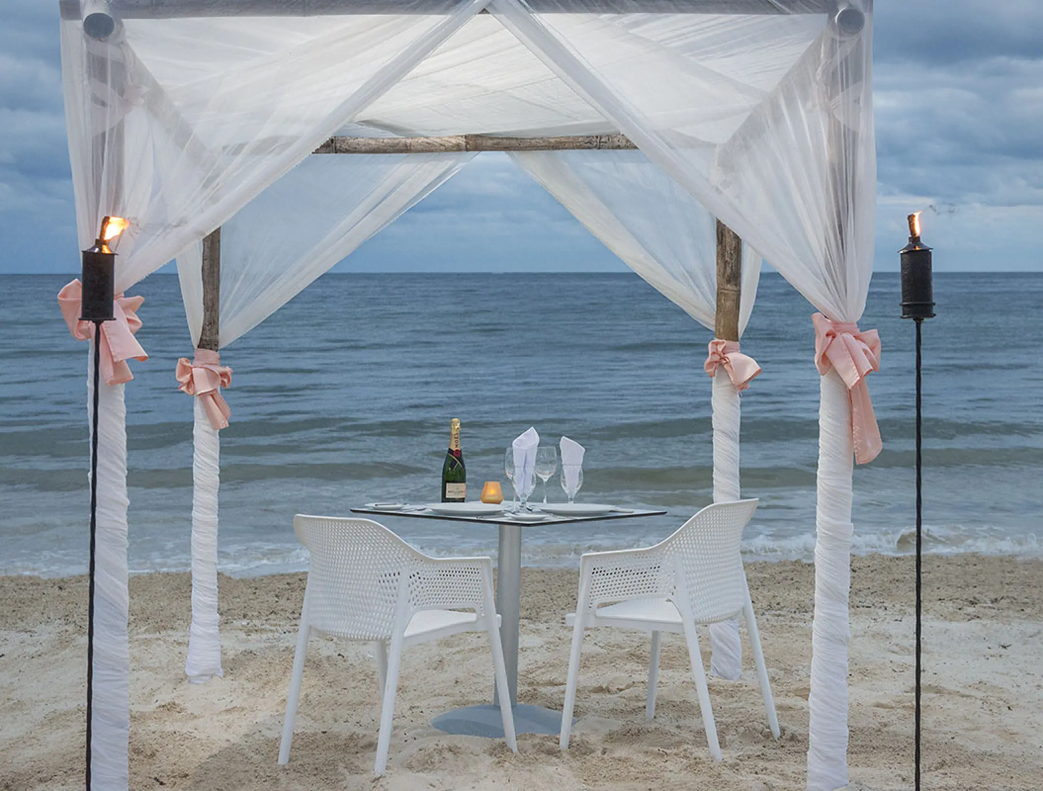 Romantic dinner setup under a white draped gazebo at H10 Ocean Coral & Turquesa, Riviera Maya