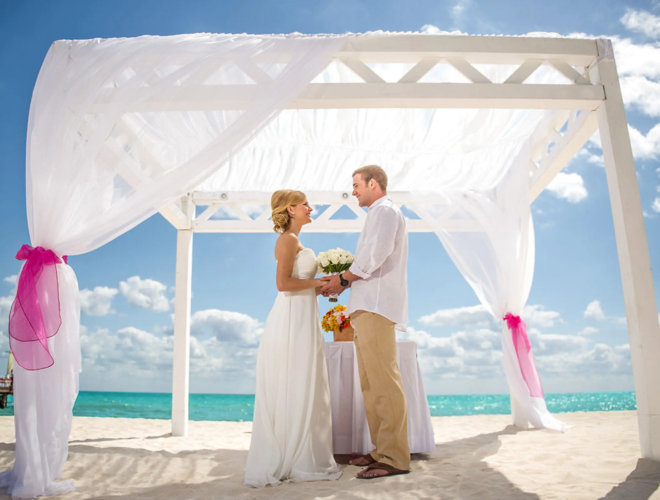 Beachfront wedding ceremony under a white gazebo at Ocean Coral & Turquesa, Riviera Maya
