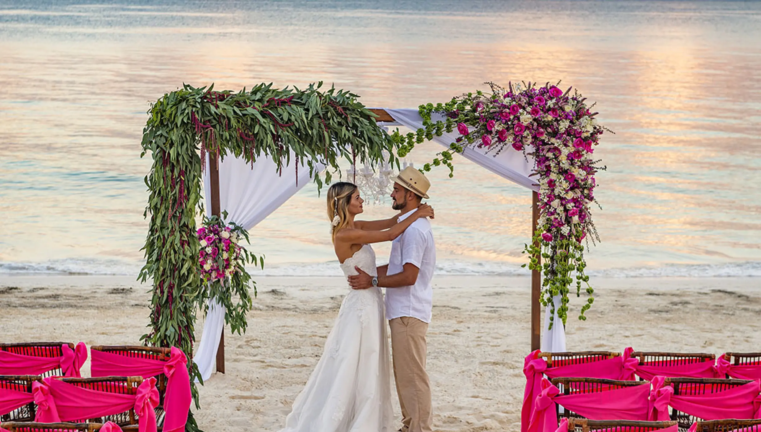 Couple celebrating their Beach Wedding ceremony at Ocean Coral and Turquesa Resort.