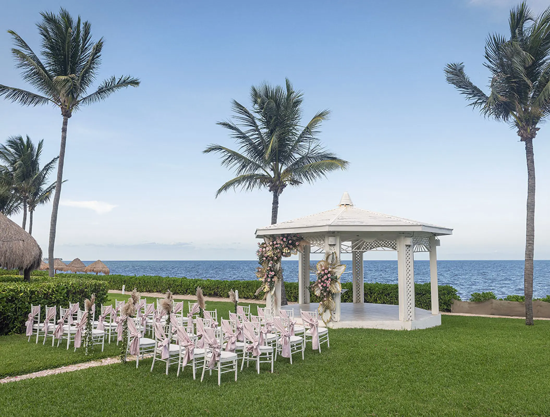 Garden gazebo wedding ceremony with floral decor at H10 Ocean Coral & Turquesa, Riviera Maya