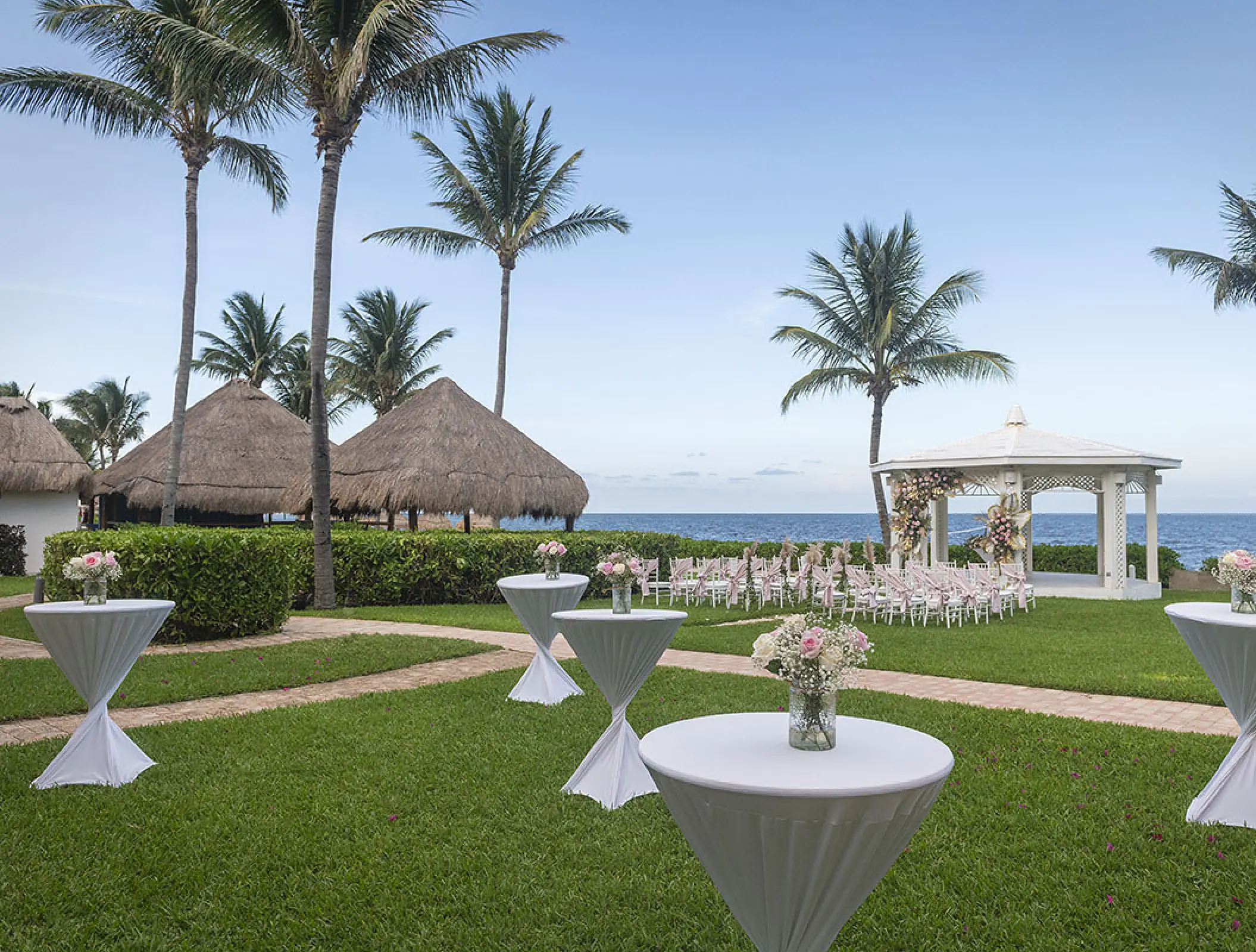 Garden gazebo wedding ceremony setup with cocktail tables at Ocean Coral & Turquesa, Riviera Maya