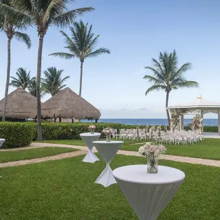 Garden gazebo wedding ceremony setup with cocktail tables at Ocean Coral & Turquesa, Riviera Maya