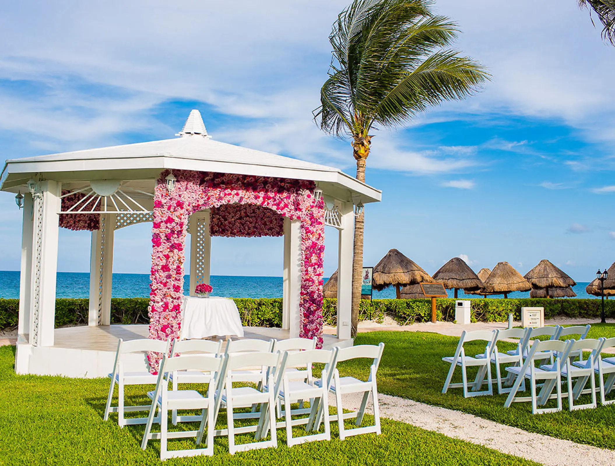 Garden gazebo wedding ceremony with pink floral arch at Ocean Coral & Turquesa, Riviera Maya