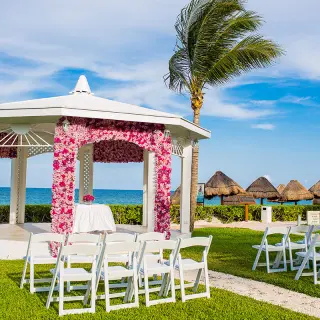 Garden gazebo wedding ceremony with pink floral arch at Ocean Coral & Turquesa, Riviera Maya