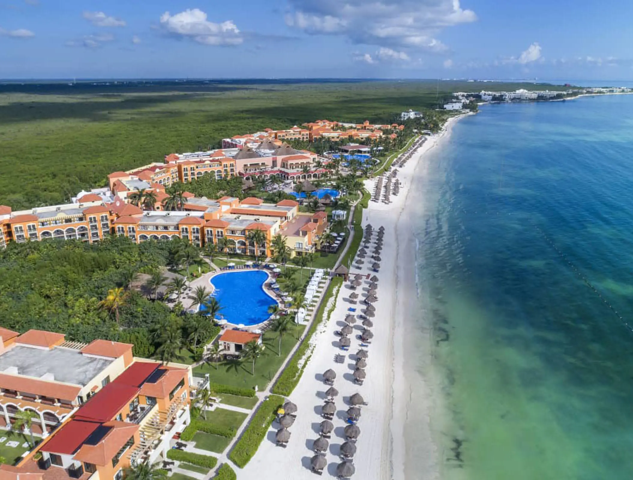 Aerial view of Ocean Coral & Turquesa resort grounds, pools and beachfront, Riviera Maya