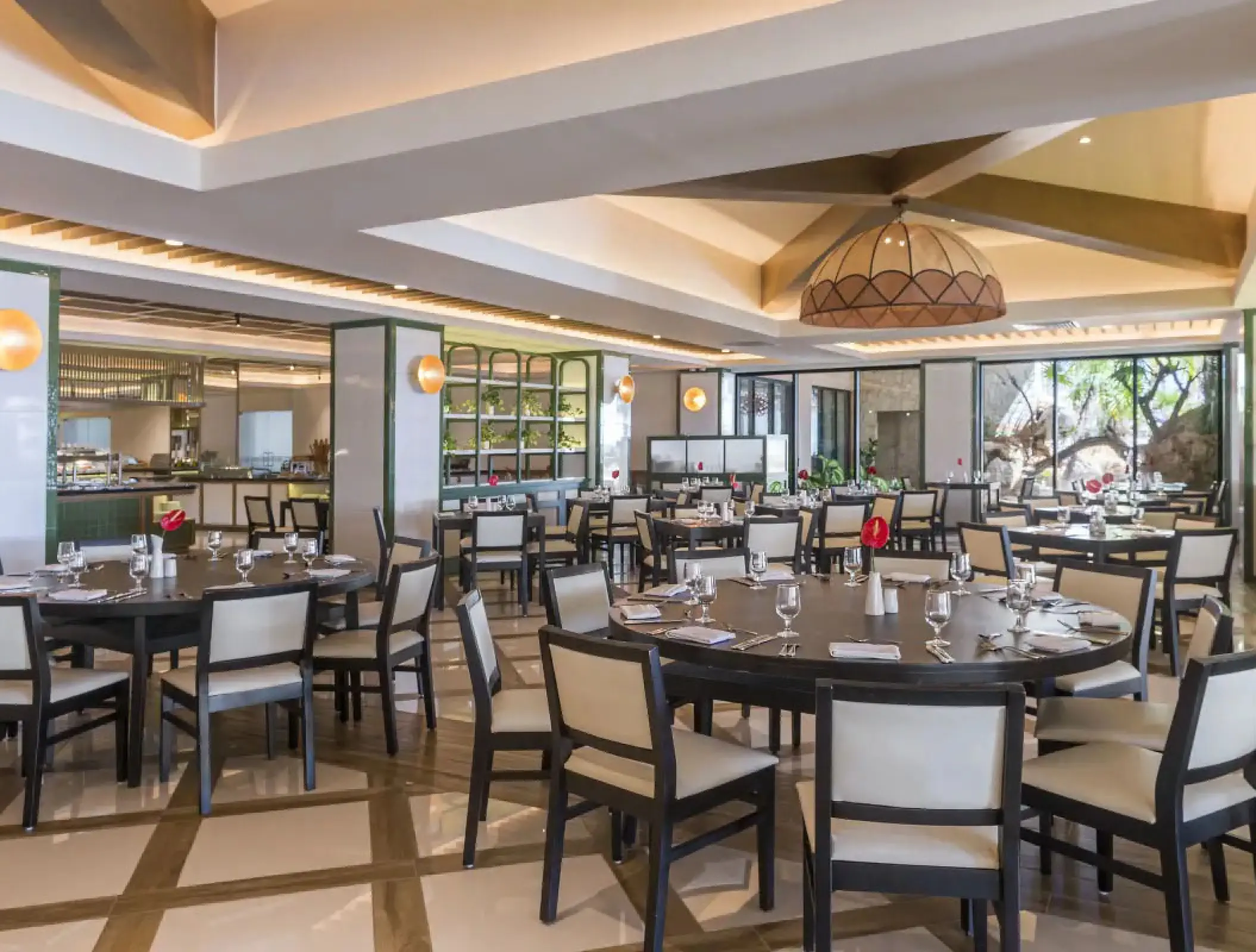 Buffet dining room with round tables and white chairs at H10 Ocean Coral & Turquesa, Riviera Maya