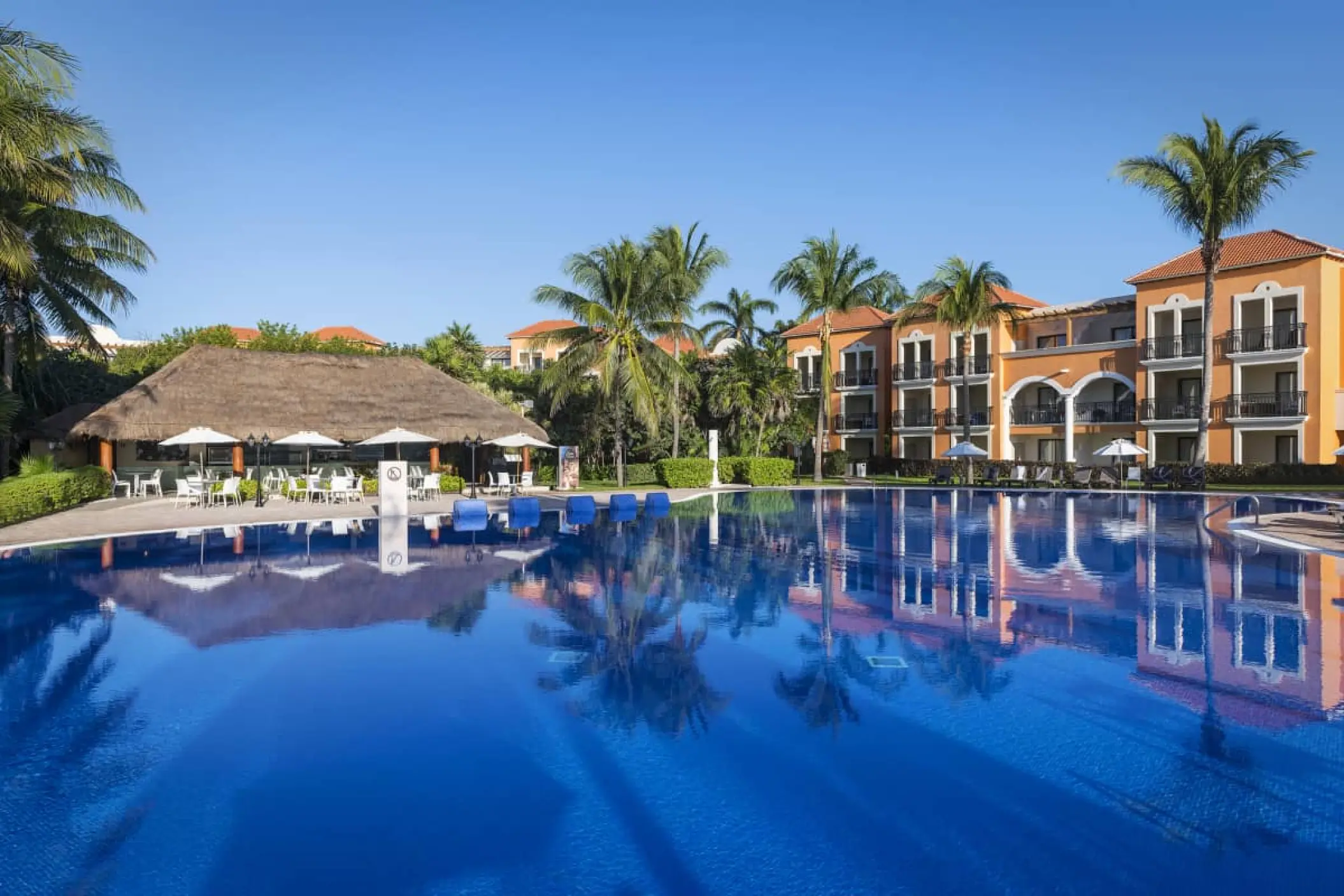 Main swimming pool and palapa restaurant at H10 Ocean Coral & Turquesa, Riviera Maya