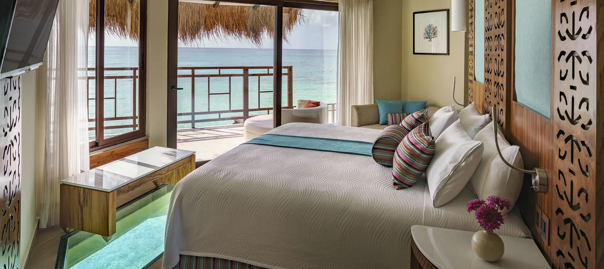 Overwater bungalow suite with glass floor panel and ocean view at El Dorado Palafitos, Riviera Maya