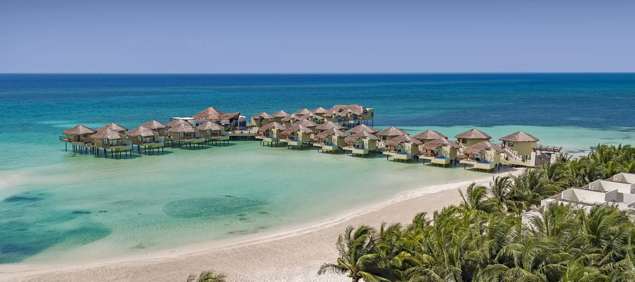 Aerial view of El Dorado Palafitos overwater bungalows on turquoise water, Riviera Maya