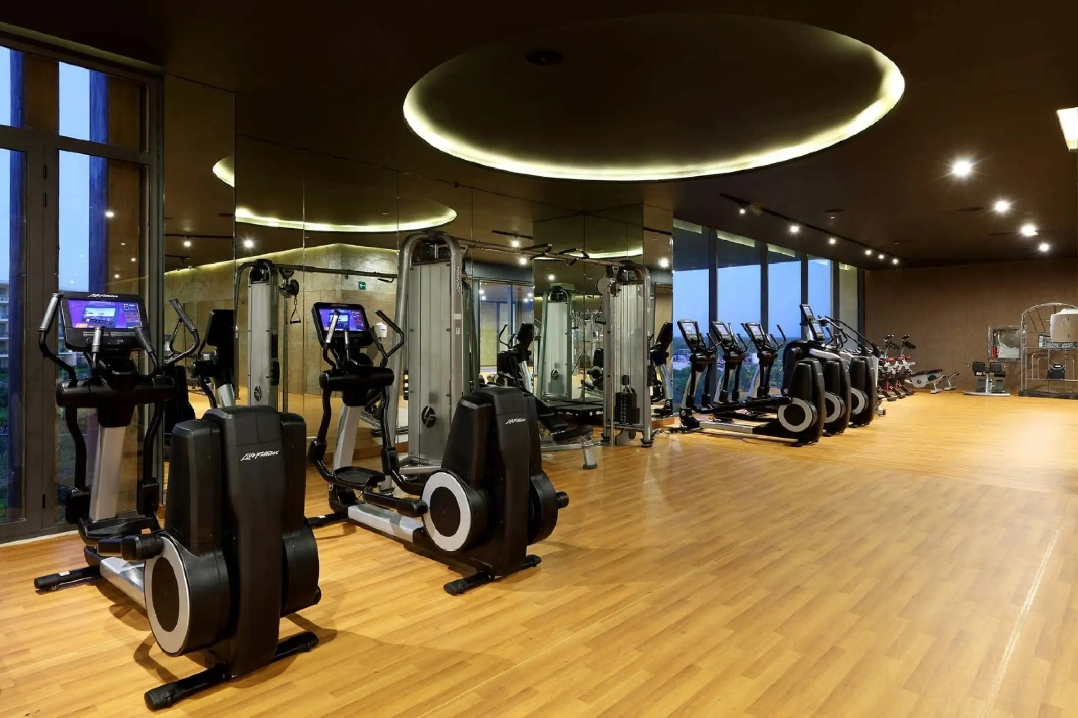 Grand Palladium Costa Mujeres gym area with elliptical machines and wood flooring, Cancun