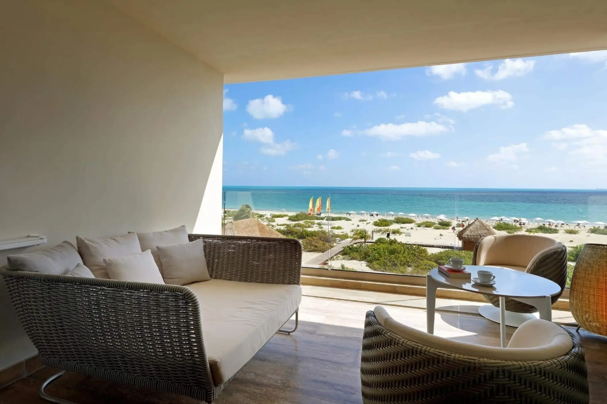 Private balcony with lounge seating overlooking the beach at Grand Palladium Costa Mujeres, Cancun