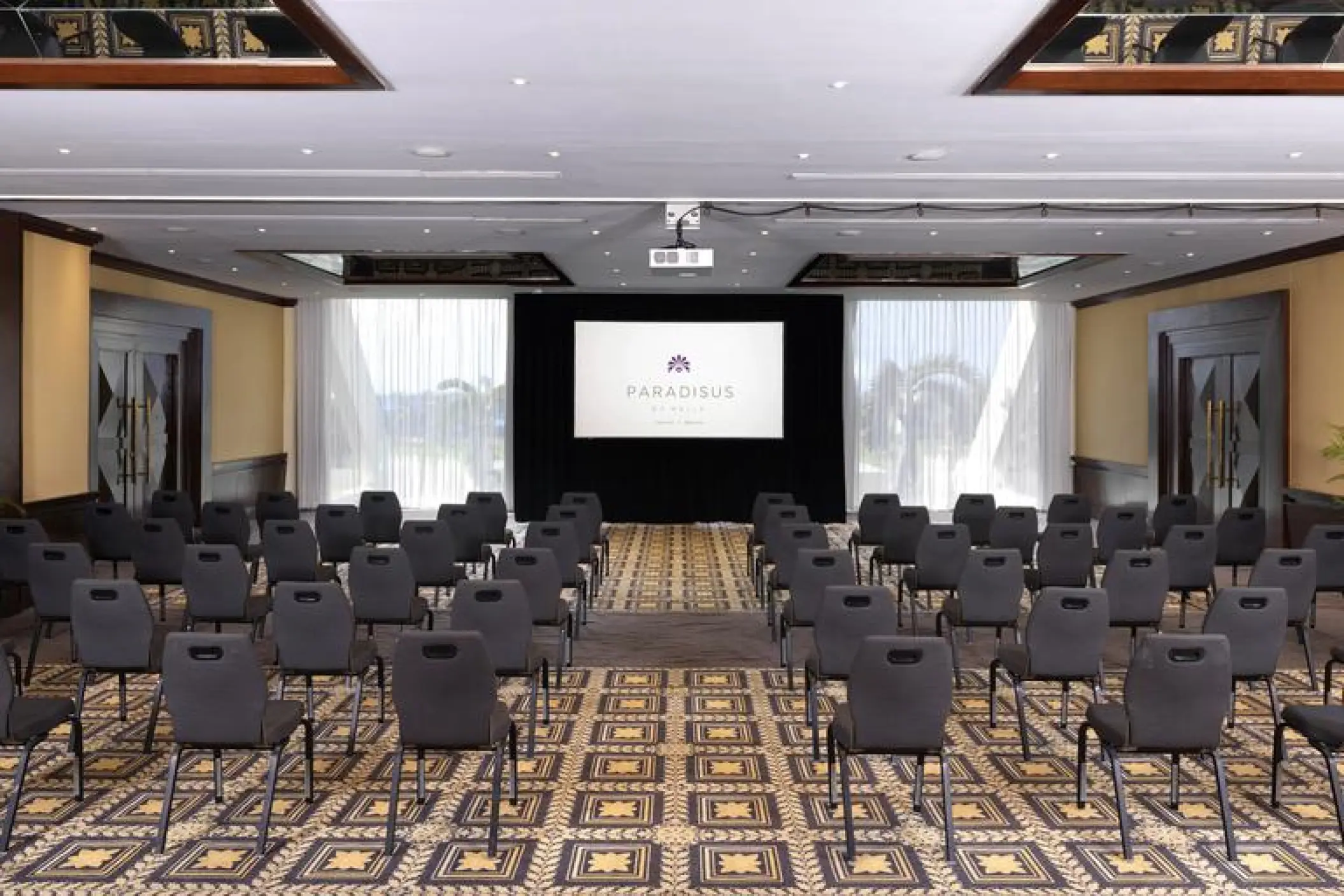 Indoor ballroom set for a presentation with rows of chairs at Paradisus Cancun