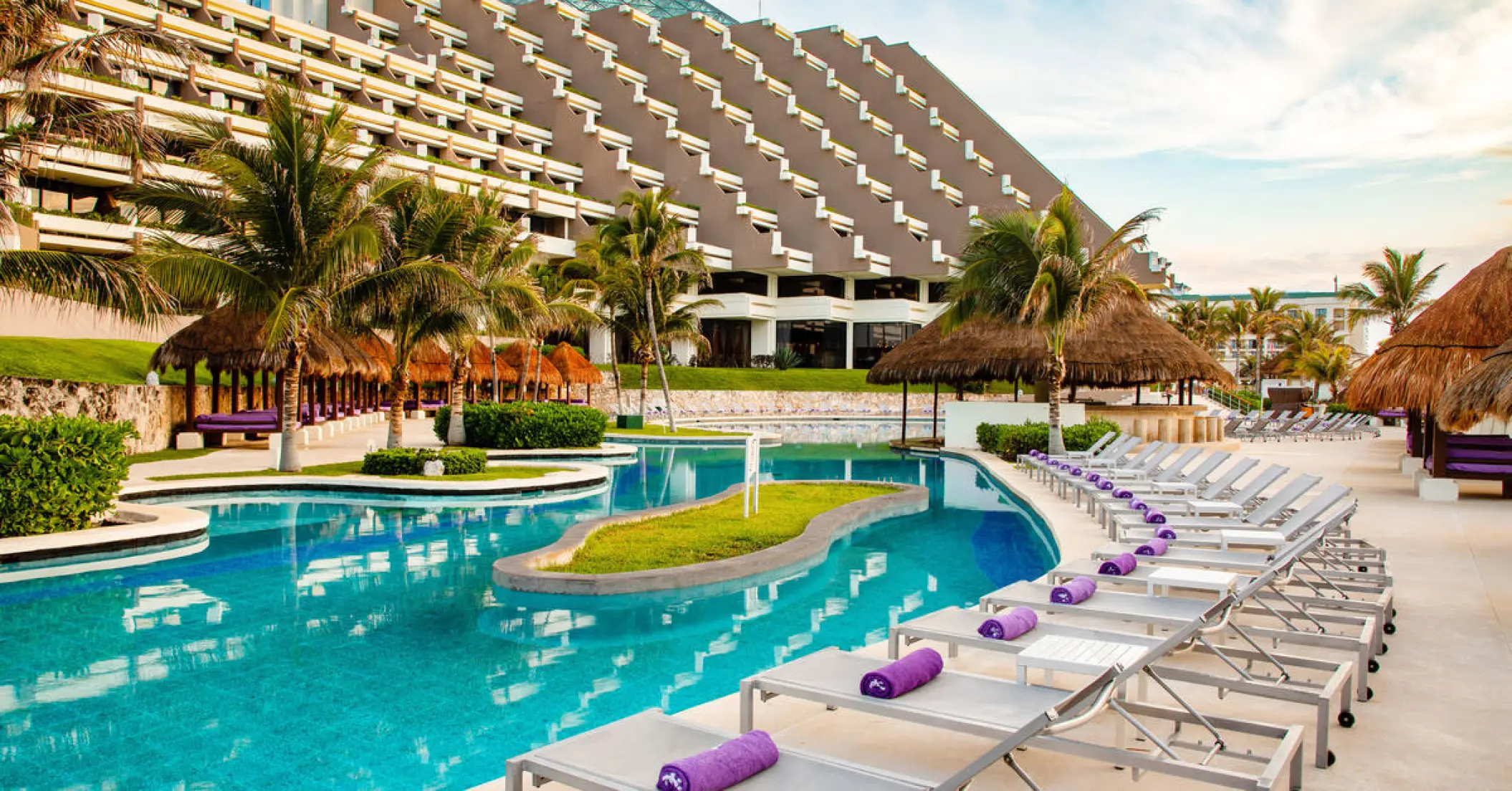Paradisus Cancun main pool and lounge chairs in front of iconic pyramid building, Cancun