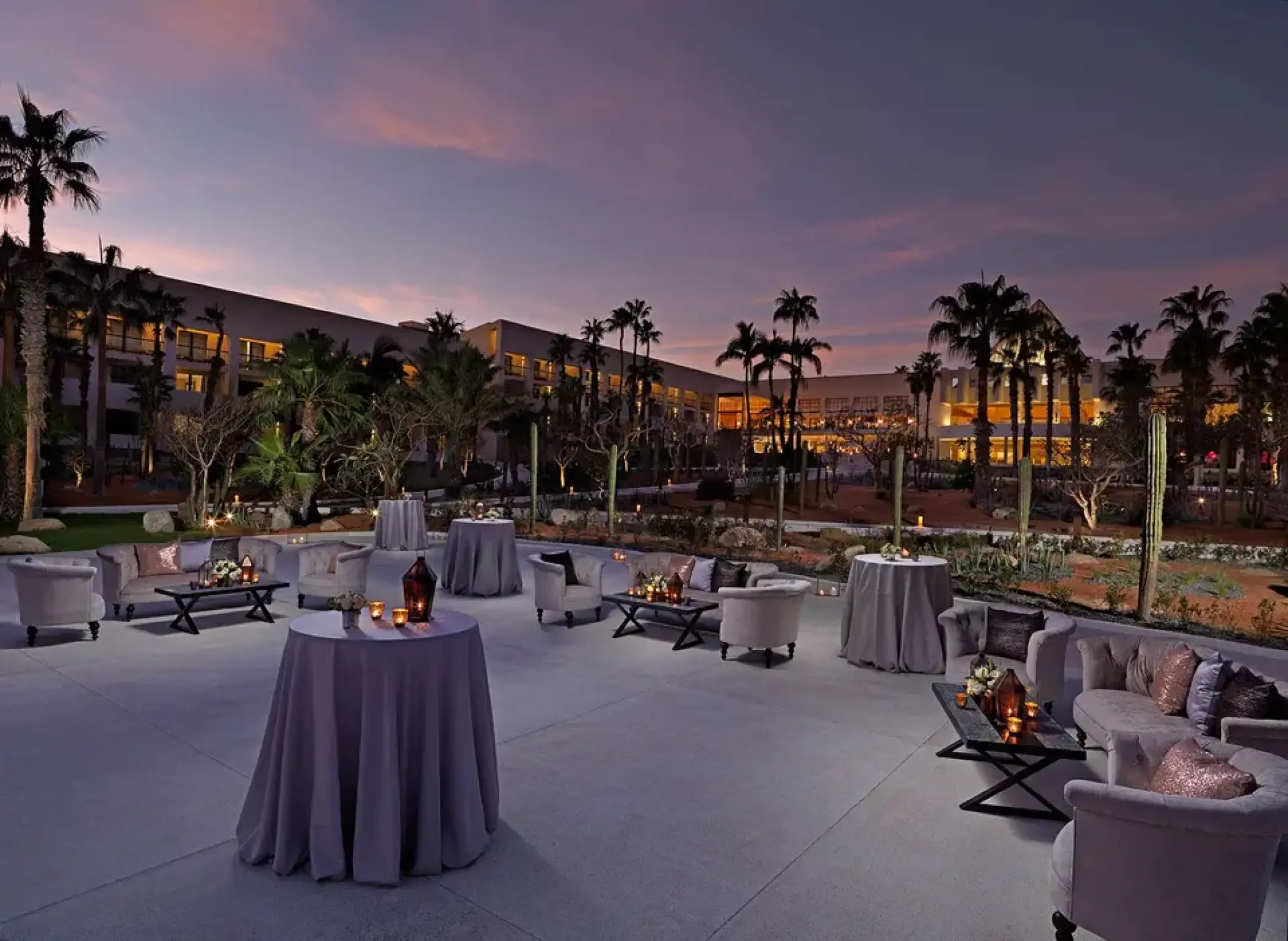 Outdoor reception setup with lounge seating at twilight in Paradisus Los Cabos, Cabo San Lucas