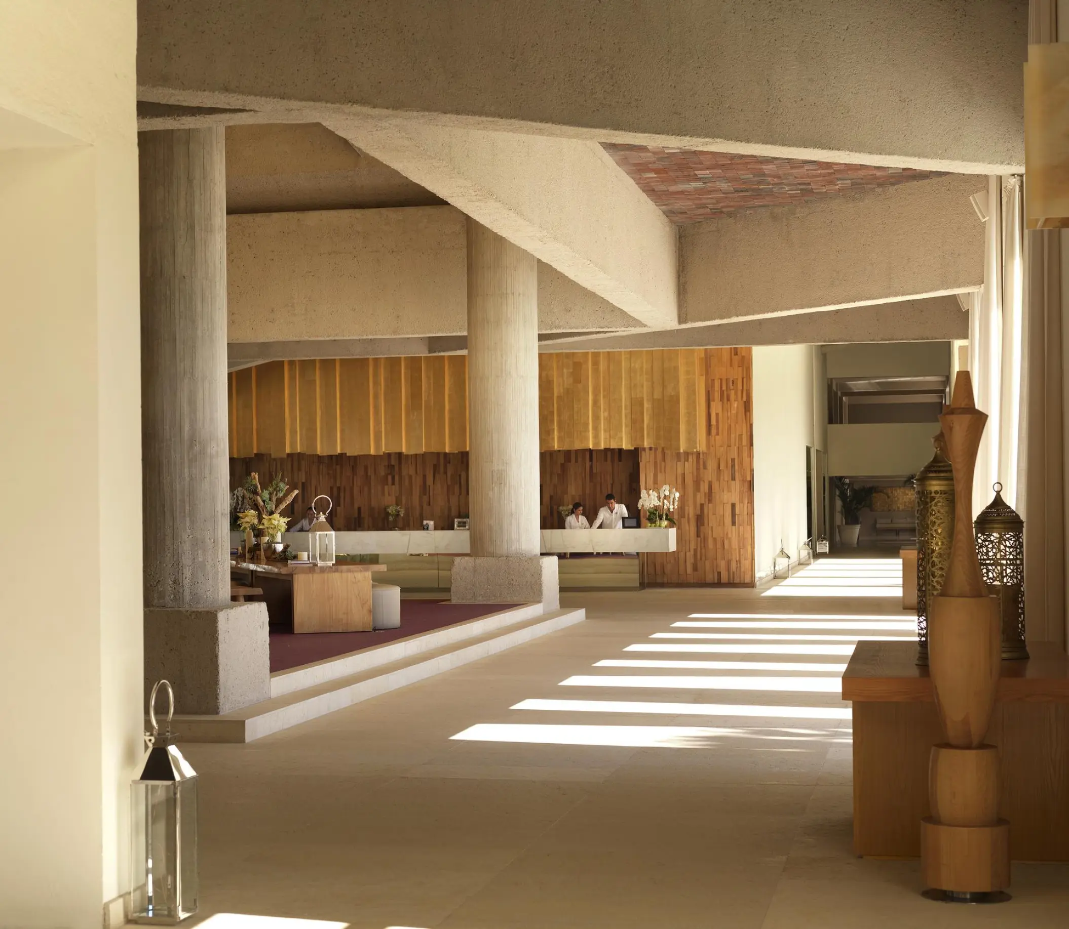 Paradisus Los Cabos lobby featuring modern concrete pillars and wood accents, Cabo San Lucas
